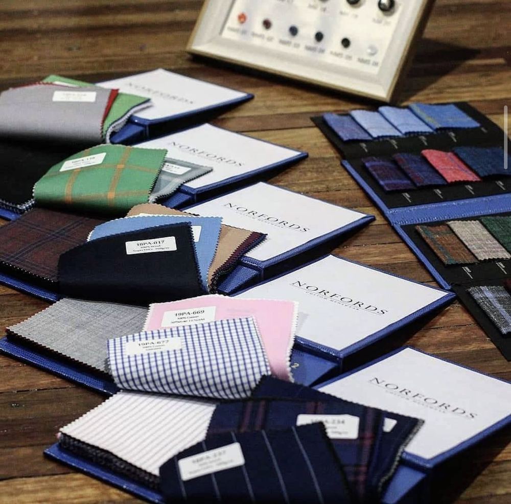 Books of cloth swatches in different weaves and colours